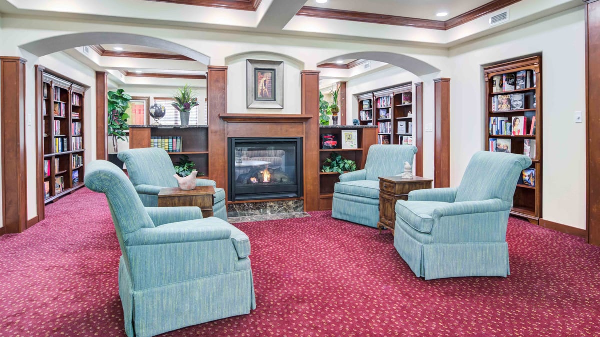 The library at Linwood Estates with shelves of books and comfortable seating